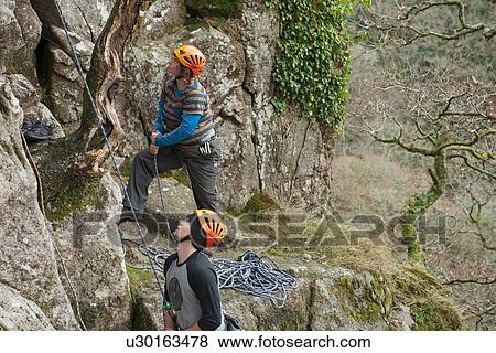 Two rock climbers looking up View Large Photo Image Stock Photo - Two rock climbers looking up. Fotosearch
