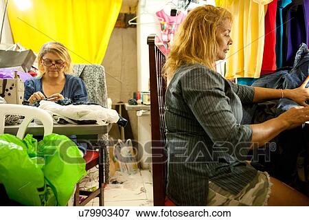 Two seamstresses working at sewing machines in workshop View Large Photo Image Stock Photo - Two seamstresses working at sewing machines in workshop. Fotosearch