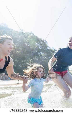 "Two women and girl running into sea, Hot Water Beach, Bay of Islands, New Zealand" View Large Photo Image Stock Photo - "Two women and girl running into sea, Hot Water Beach, Bay of Islands, New Zealand". Fotosearch