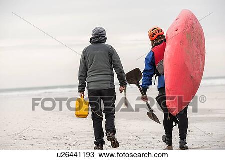 Two women on beach with kayak View Large Photo Image Stock Image - Two women on beach with kayak. Fotosearch