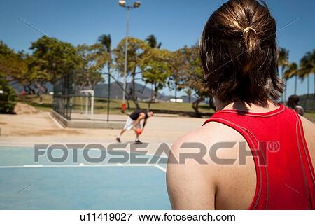 Two young men playing basketball on basketball court View Large Photo Image Stock Photo - Two young men playing basketball on basketball court. Fotosearch