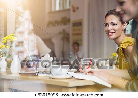 Stock Photograph - Two young women having meeting in cafe. Fotosearch