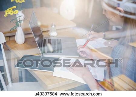 "Two young women having meeting in cafe, view through window" View Large Photo Image Picture - "Two young women having meeting in cafe, view through window". Fotosearch