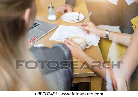 "Two young women having meeting in cafe, rear view" View Large Photo Image Stock Image - "Two young women having meeting in cafe, rear view". Fotosearch
