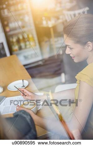 Stock Photography - "Two young women having meeting in cafe, rear view". Fotosearch