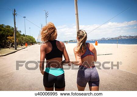 "Two young women jogging on beach, rear view" View Large Photo Image Stock Photography - "Two young women jogging on beach, rear view". Fotosearch