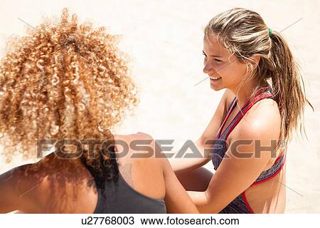 Stock Image - "Two young women talking, high angle". Fotosearch