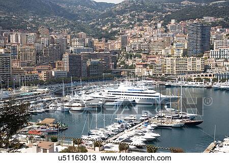 "View of luxury yachts moored in harbor, Montecarlo, Monaco" View Large Photo Image Stock Image - "View of luxury yachts moored in harbor, Montecarlo, Monaco". Fotosearch