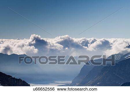 "View of mountains and low cloud over valley, Jungfrauchjoch, Grindelwald, Switzerland" View Large Photo Image Stock Photograph - "View of mountains and low cloud over valley, Jungfrauchjoch, Grindelwald, Switzerland". Fotosearch