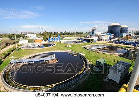 Picture - View of sludge treatment pool and storage tanks at sewage treatment plant. Fotosearch