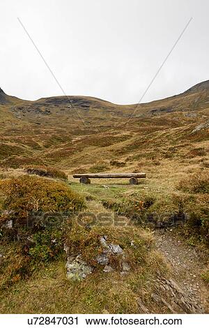 Stock Image - "View of wooden bench on hillside, Grindelwald, Switzerland". Fotosearch