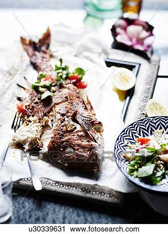 Stock Image - Whole Snapper Burghul Salad. Fotosearch