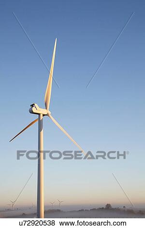 Stock Photo - Wind turbine against blue sky. Fotosearch