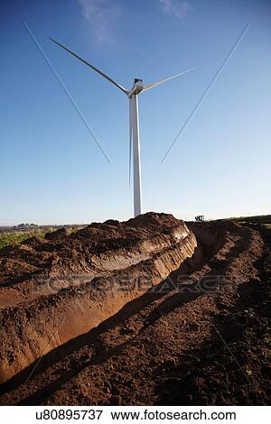 Stock Photo - Wind turbine against blue sky. Fotosearch