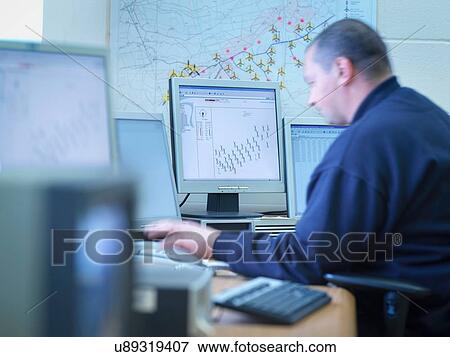 Windfarm engineer working in windfarm control room View Large Photo Image Stock Photo - Windfarm engineer working in windfarm control room. Fotosearch
