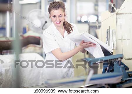 Woman at press machine in laundry View Large Photo Image Stock Photo - Woman at press machine in laundry. Fotosearch
