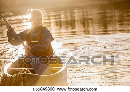 Stock Image - Woman canoeing. Fotosearch