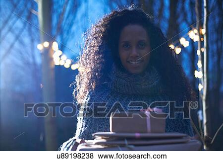 Woman carrying presents to celebration in countryside View Large Photo Image Stock Photo - Woman carrying presents to celebration in countryside. Fotosearch