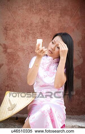 "Woman in chinese dress, putting on make up, Beijing, China" View Large Photo Image Stock Photography - "Woman in chinese dress, putting on make up, Beijing, China". Fotosearch