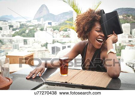"Woman laughing on terrace, Sugar Loaf Mountain in background, RIo, Brazil" View Large Photo Image Stock Photo - "Woman laughing on terrace, Sugar Loaf Mountain in background, RIo, Brazil". Fotosearch