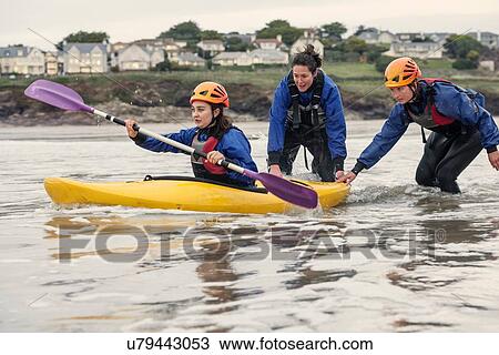 Stock Image - "Woman learning how to sea kayak, Cornwall, England". Fotosearch