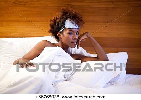 Woman lying in bed View Large Photo Image Stock Photo - Woman lying in bed. Fotosearch
