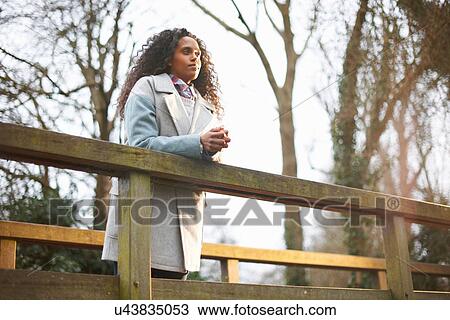 "Woman on bridge, in countryside" View Large Photo Image Stock Image - "Woman on bridge, in countryside". Fotosearch