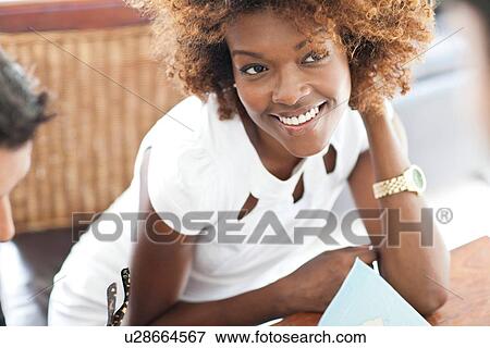 Woman resting elbow on desk View Large Photo Image Stock Photo - Woman resting elbow on desk. Fotosearch