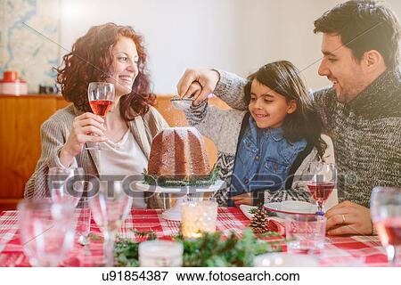 Woman serving desert at family Christmas party View Large Photo Image Stock Photo - Woman serving desert at family Christmas party. Fotosearch