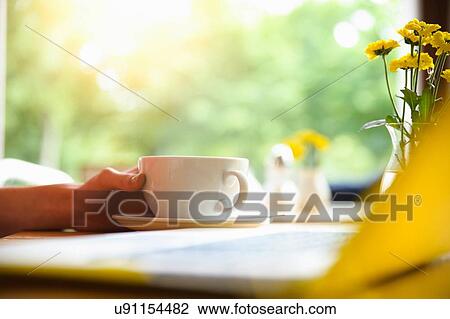 Stock Image - Woman using laptop at coffee break. Fotosearch