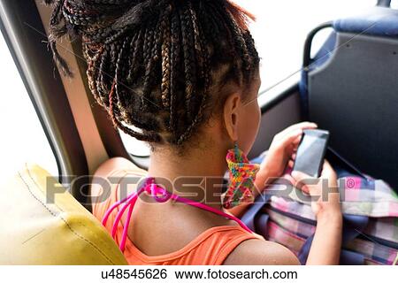 "Woman using smartphone on bus, Rio de Janeiro, Brazil" View Large Photo Image Stock Photograph - "Woman using smartphone on bus, Rio de Janeiro, Brazil". Fotosearch