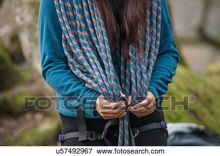 Stock Photo - Woman with climbing rope around neck. Fotosearch