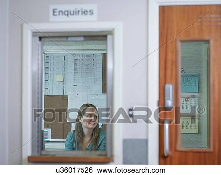 Woman working at enquiries desk in factory View Large Photo Image Stock Photograph - Woman working at enquiries desk in factory. Fotosearch