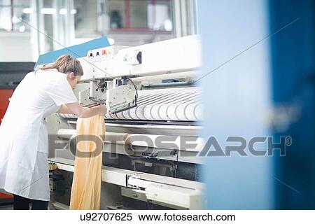 Woman working at machinery in laundry View Large Photo Image Stock Photography - Woman working at machinery in laundry. Fotosearch