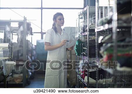 Stock Image - Woman working in laundry. Fotosearch