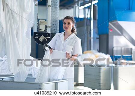 Woman working in laundry View Large Photo Image Stock Image - Woman working in laundry. Fotosearch