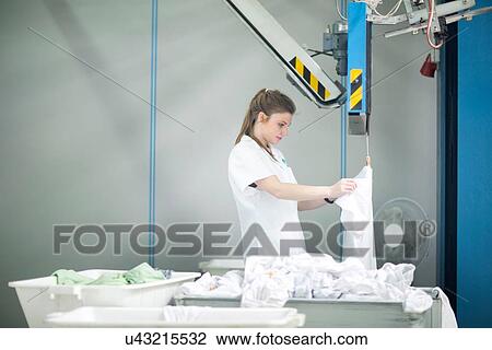 Stock Image - Woman working in laundry. Fotosearch