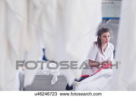 Woman working in laundry View Large Photo Image Stock Image - Woman working in laundry. Fotosearch