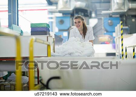 Woman working in laundry View Large Photo Image Stock Image - Woman working in laundry. Fotosearch