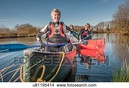 Women canoeing on river View Large Photo Image Picture - Women canoeing on river. Fotosearch