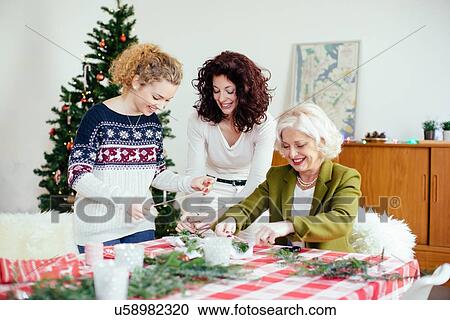 Stock Image - Women preparing for family Christmas party. Fotosearch