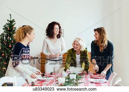 Women preparing for family Christmas party View Large Photo Image Stock Image - Women preparing for family Christmas party. Fotosearch