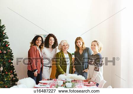 Stock Photo - Women preparing for family Christmas party. Fotosearch