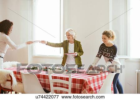 Stock Photo - Women preparing for family Christmas party. Fotosearch