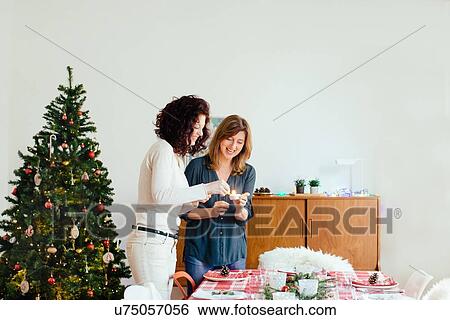 Stock Photograph - Women preparing for family Christmas party. Fotosearch