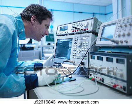 Worker checking electronics in clean room laboratory View Large Photo Image Stock Image - Worker checking electronics in clean room laboratory. Fotosearch