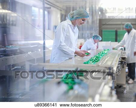 Worker inspecting chocolate on production line in chocolate factory View Large Photo Image Stock Image - Worker inspecting chocolate on production line in chocolate factory. Fotosearch