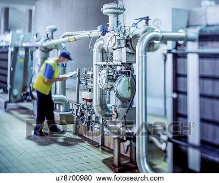 Worker inspecting water filtration in brewery View Large Photo Image Stock Image - Worker inspecting water filtration in brewery. Fotosearch