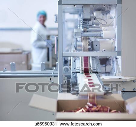 Worker inspecting wrapped chocolates on production line in chocolate factory View Large Photo Image Stock Image - Worker inspecting wrapped chocolates on production line in chocolate factory. Fotosearch