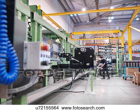 Worker operating carbon fibre loom in carbon fibre factory View Large Photo Image Picture - Worker operating carbon fibre loom in carbon fibre factory. Fotosearch